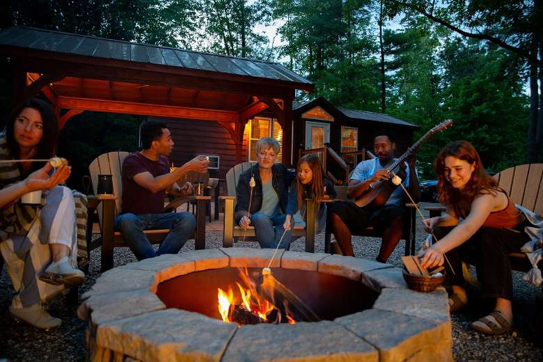 Group of people sitting around a campfire