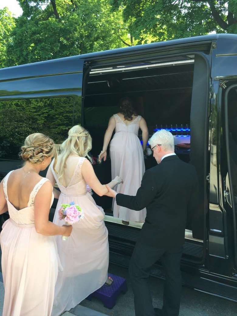 bridal party climbing into a premier plus travel and tours van