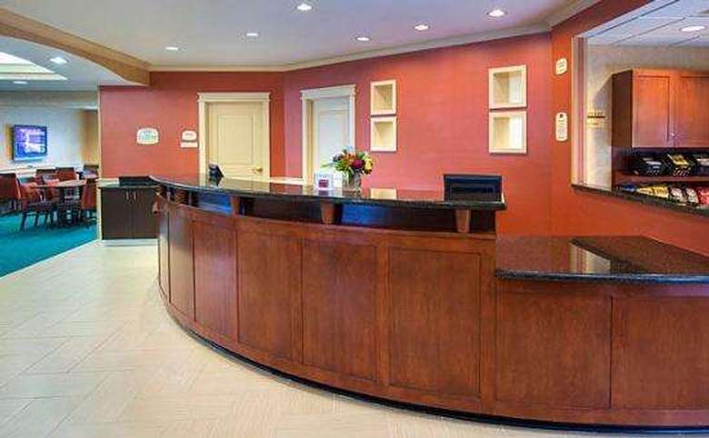 hotel front desk with a red accent wall