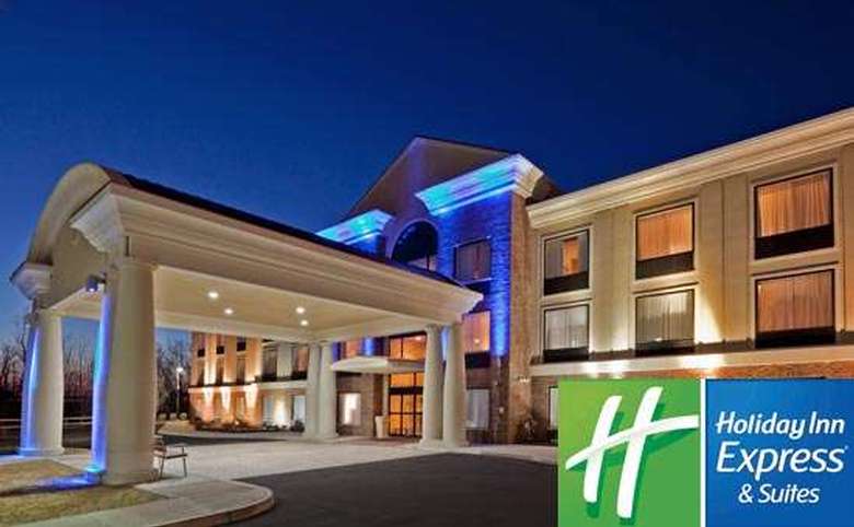 exterior of holiday inn express & suites clifton park with hotel logo in lower right corner
