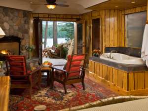 a hot tub in a living room with as tone fire place, view of a patio outside