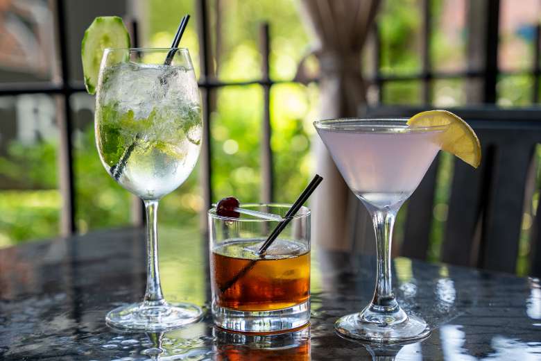 Three summer seasonal cocktails on an outdoor patio table