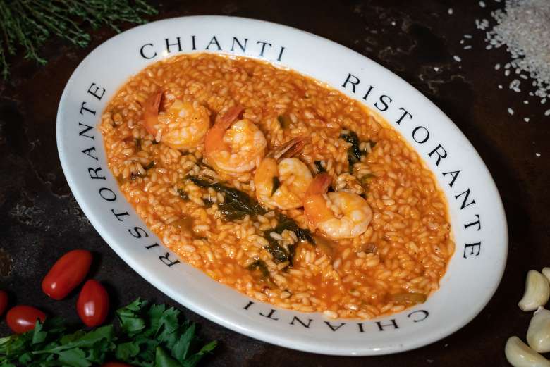 Risotta with shrimp on a white plate
