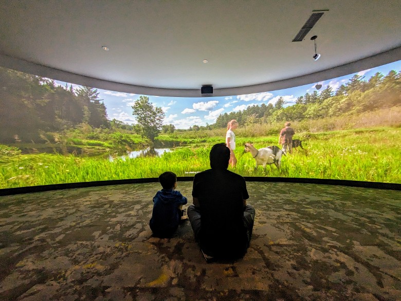 the back of a dad and son at the wilderness stories indtruction theater