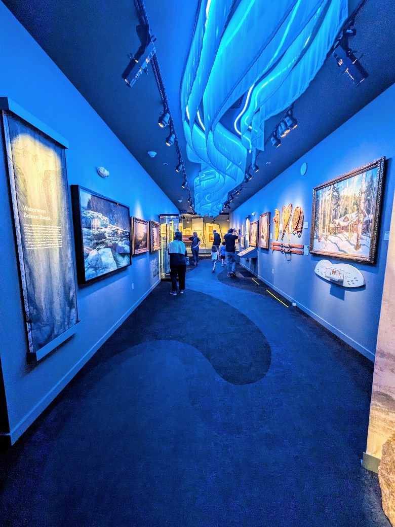 paintings on the wall with blue lights