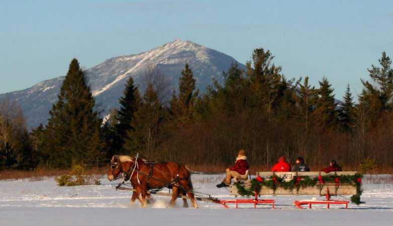 a winter sleigh ride with mountains in the background