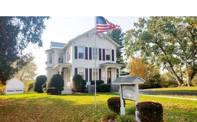 Exterior of a Funeral Home with American flag in front of it