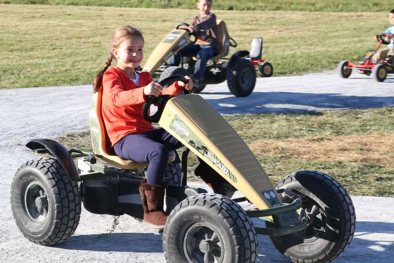 kids riding motorized four-wheel vehicles