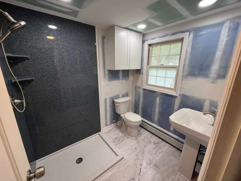 a modern bathroom with a shower, toilet, and sink