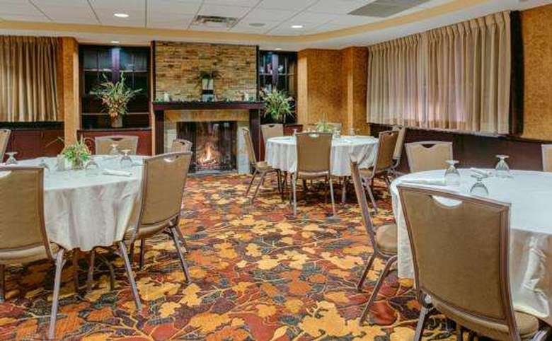 meeting room set up in banquet style with fireplace in background
