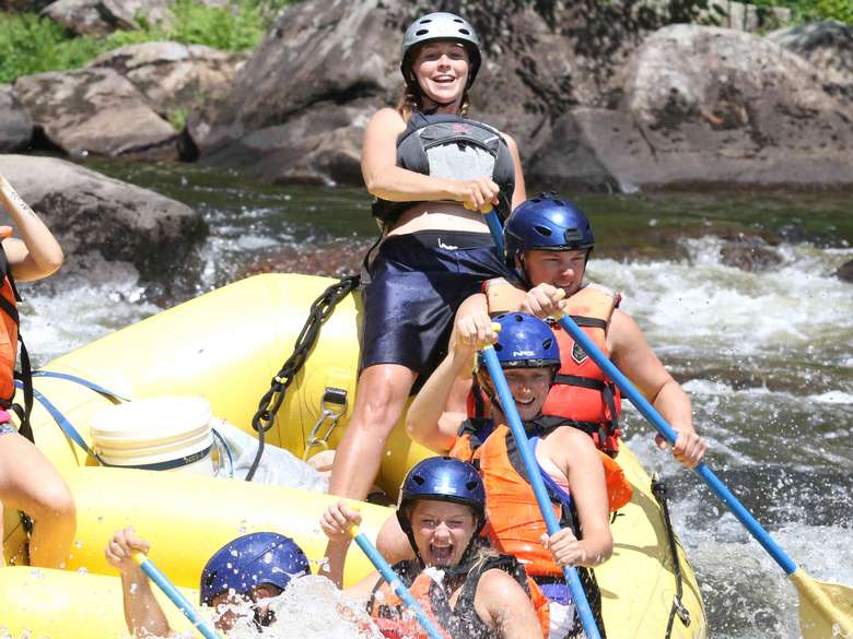 a group of rafters paddling through rapids on a river