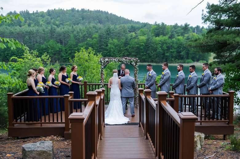 wedding party in front of lake