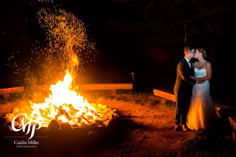 bride and groom by fire