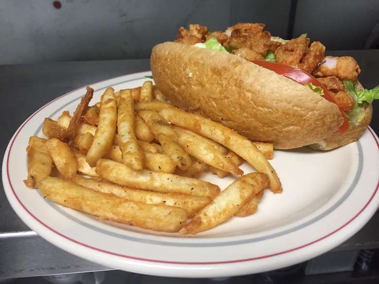 fries and a sandwich on a roll