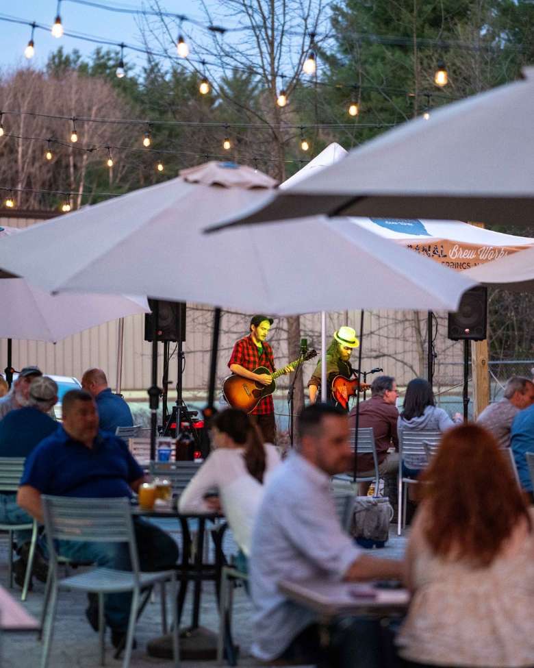 a band playing for a crowd on a patio.