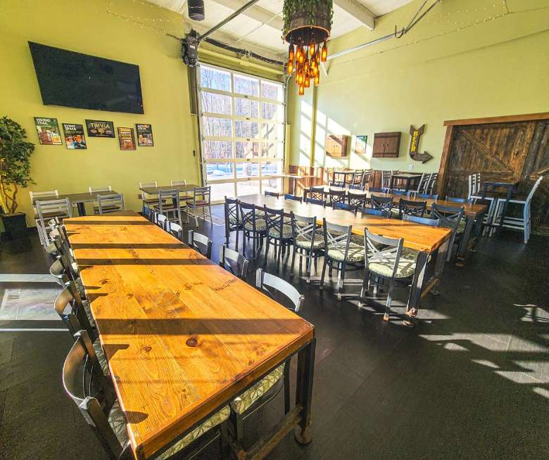 large tables with chairs inside of a taproom.