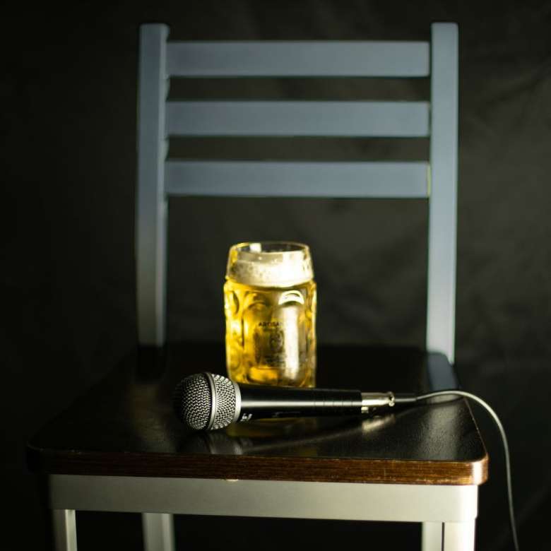 Glass of beer and a microphone on a chair