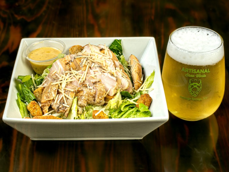 Sous vide chicken caesar salad with craft beer at Artisanal Brew Works restaurant in Saratoga Springs NY