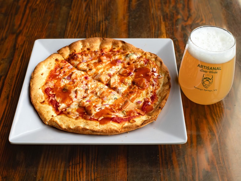 Buffalo chicken pizza served with craft beer at Nature&rsquo;s Edge Bistro at Artisanal Brew Works in Saratoga Springs.