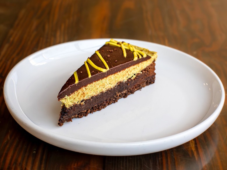 Dubai chocolate torte dessert with pistachio, tahini, and kataifi at Nature&rsquo;s Edge Bistro at Artisanal Brew Works in Saratoga Springs restaurant with outdoor dining.