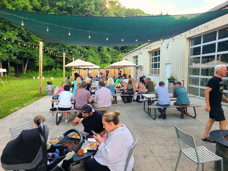 Outdoor dining with live music on the Nature&rsquo;s Edge Terrace at Artisanal Brew Works restaurant in Saratoga Springs