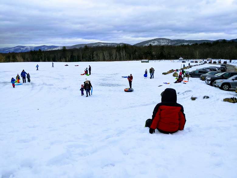 people at a sledding hill