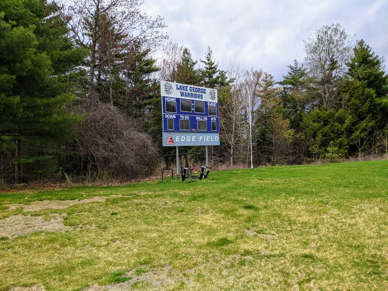 lake george warriors sign over a goal post in field