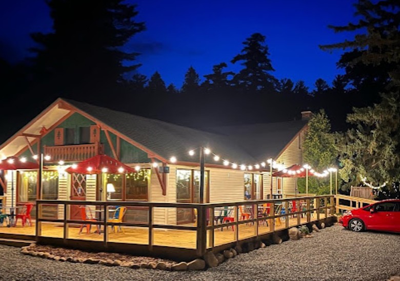 ADK Trail Inn office building with deck and chairs. Also the site of the Monday Tuesday Grill