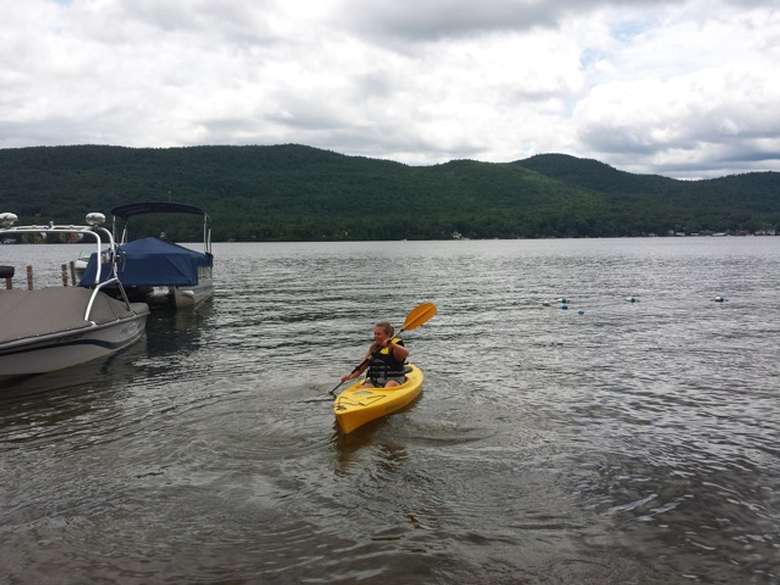 girl paddling a kayak on lake george