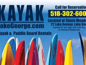 row of colorful paddleboards with text that says kayaklakegeorge.com and call for reservations 518-302-6005