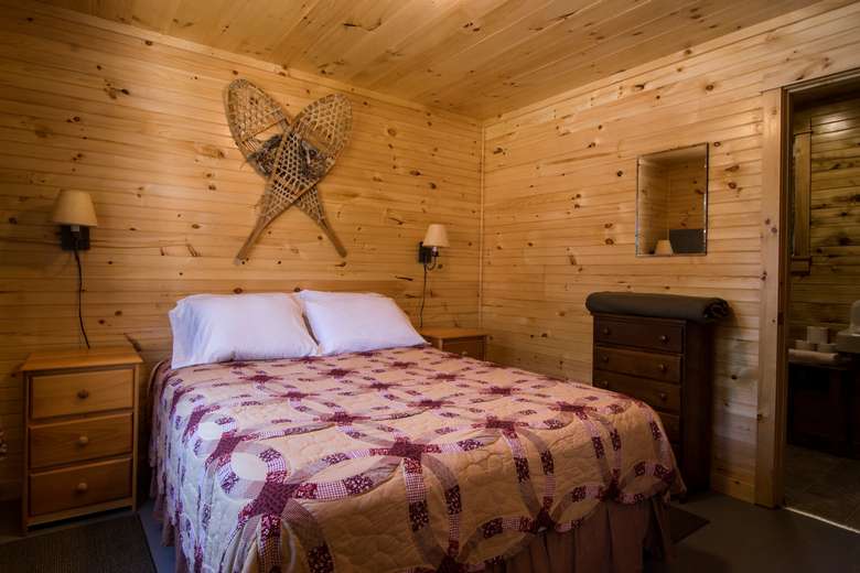 cabin number 5 queen bedroom with knotty pine walls and ceilings