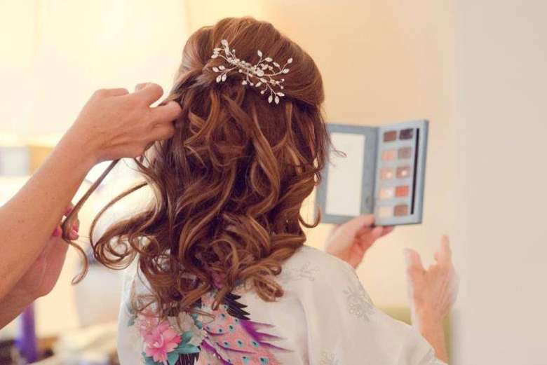 stylist working on a woman's hair