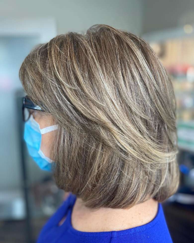 side view of an older woman's hair at a salon