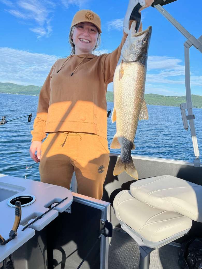 young woman holds up fish