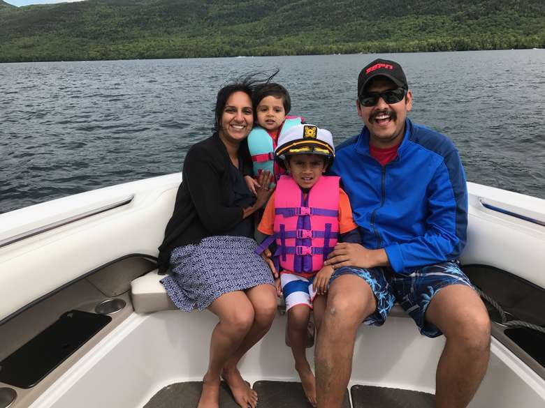 family of four on a boat