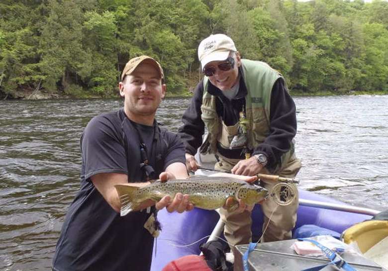 two men holding up a large fish