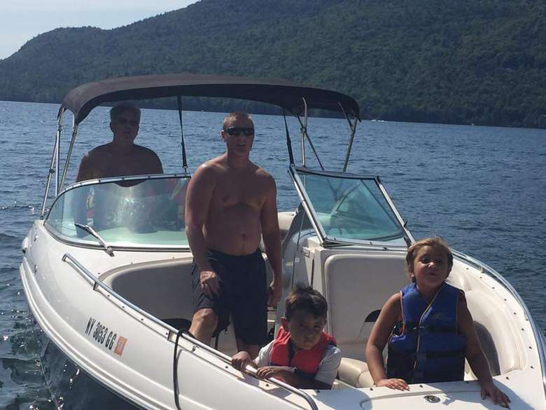 two adults and two kids on board the Chapparal Bowrider motorboat