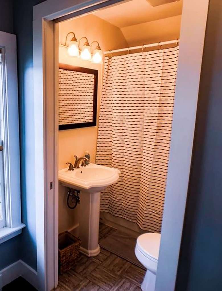 sink, toilet, and mirror in a bathroom