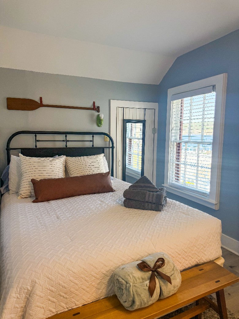 Second level bedroom with full bed and attached bathroom