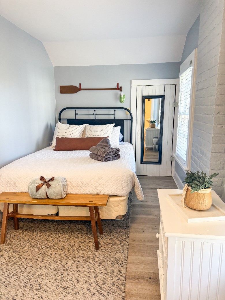 Second level bedroom with full bed and attached bathroom