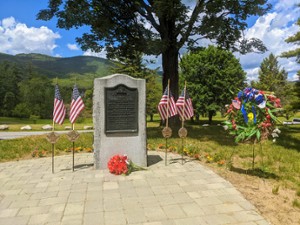 memorial with flags and flowers