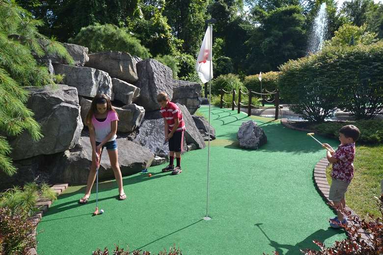 kids on a mini golf course playing