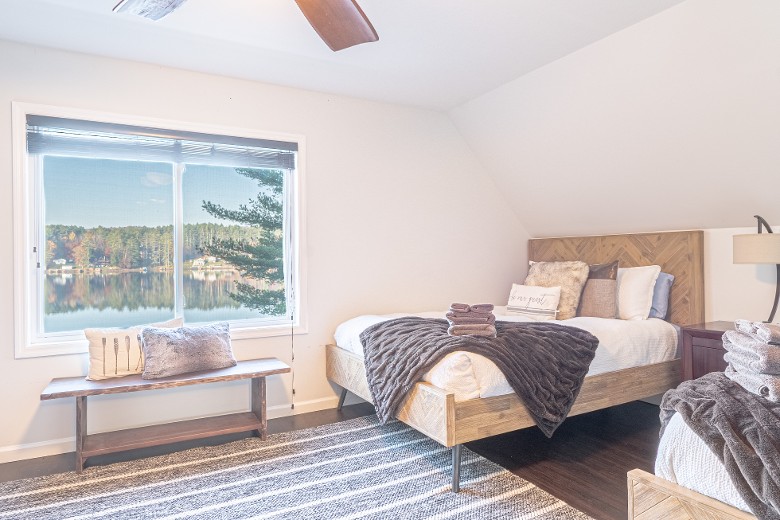 The third-level bedroom features 3 queen beds. Stunning lake views! Bedroom 4