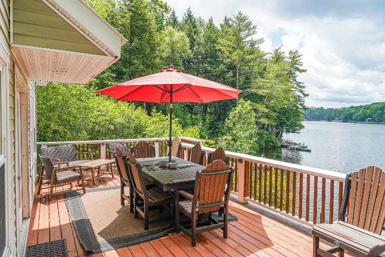 Main level deck with views, seating, dining table, and BBQ grill
