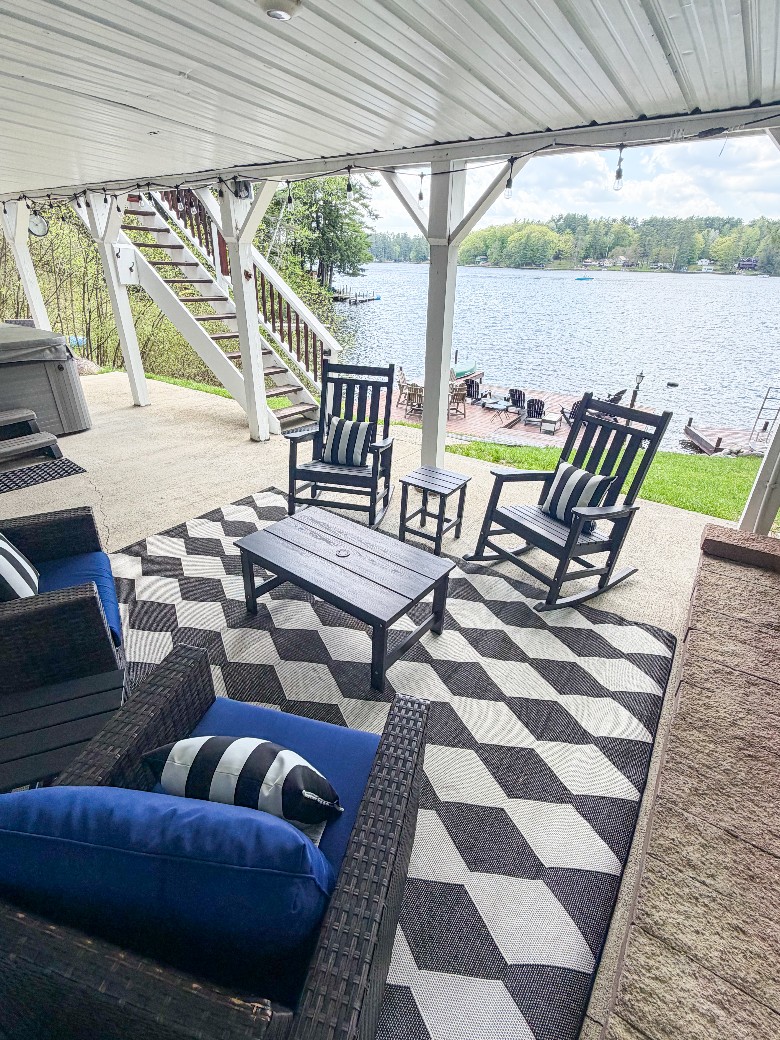 Lake-level patio area with hot tub and seating, close to the firepit and outdoor shower
