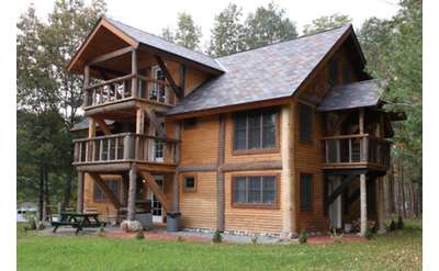 the outside of a large Adirondack-style house