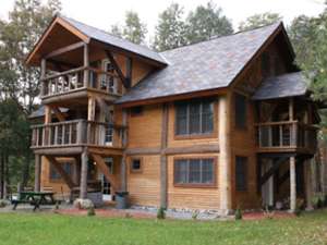 the outside of a large Adirondack-style house