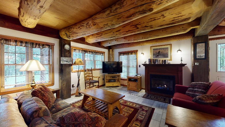 living room with a sofa, loveseat, gas fireplace and tv