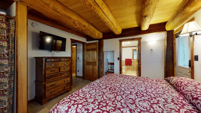 bedroom with doors open, one looking into master bath and one into hallway