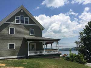 a beautiful gray house right on the lake